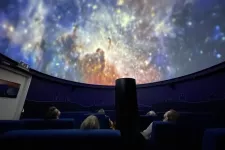 Audience watching a planetarium show. Photo.