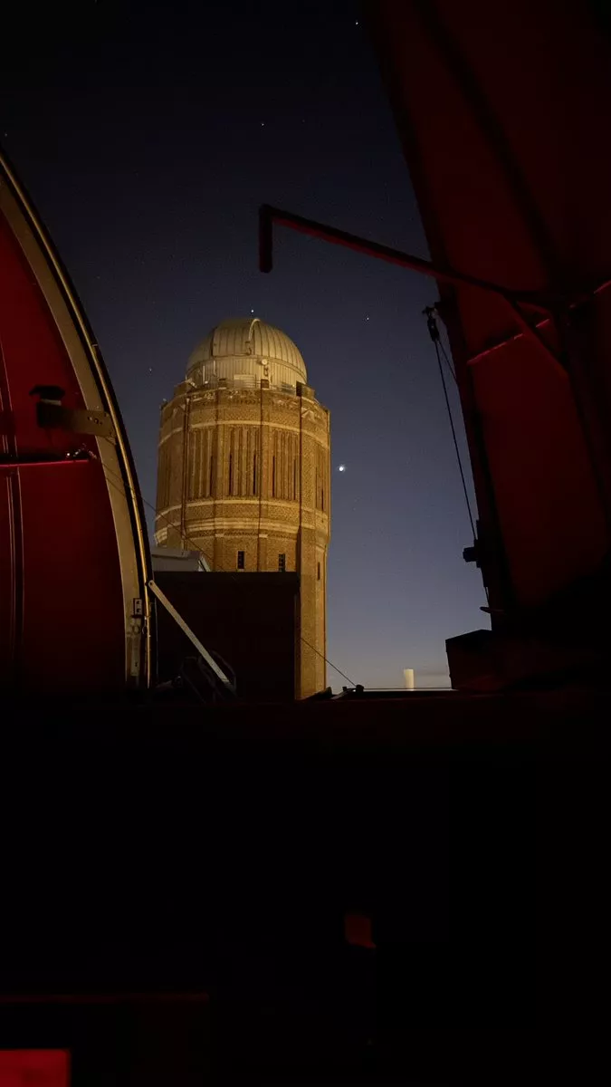 View out of the telescope dome shows the old watertower and the planet Venus. Photo.